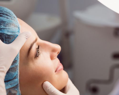 Doctor examining womans face for cosmetic treatment