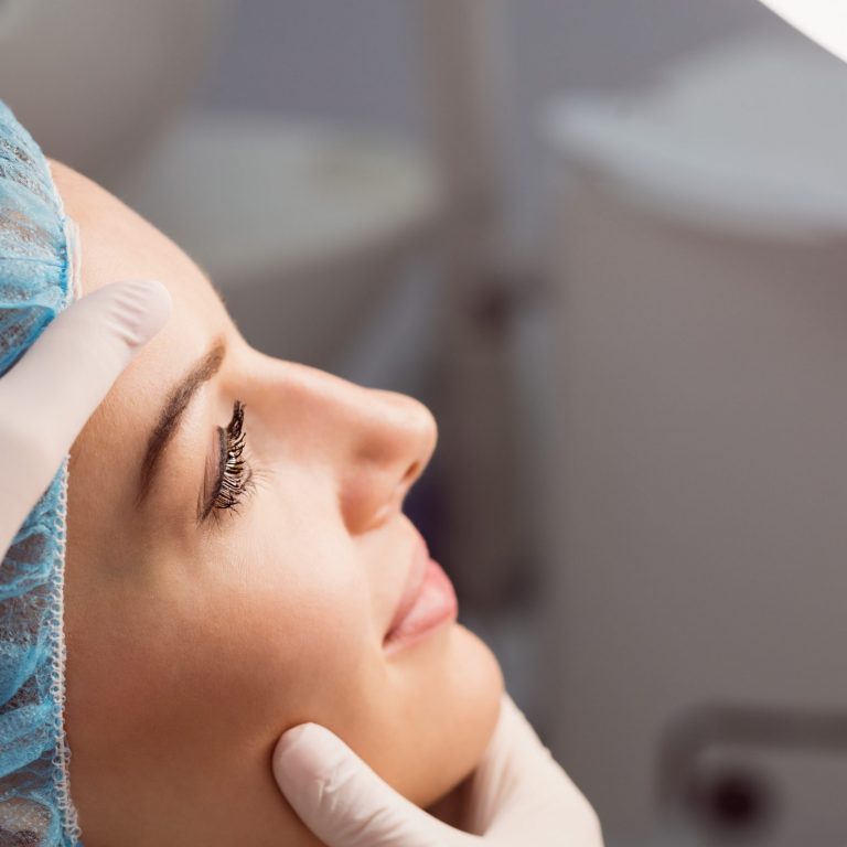 Doctor examining womans face for cosmetic treatment